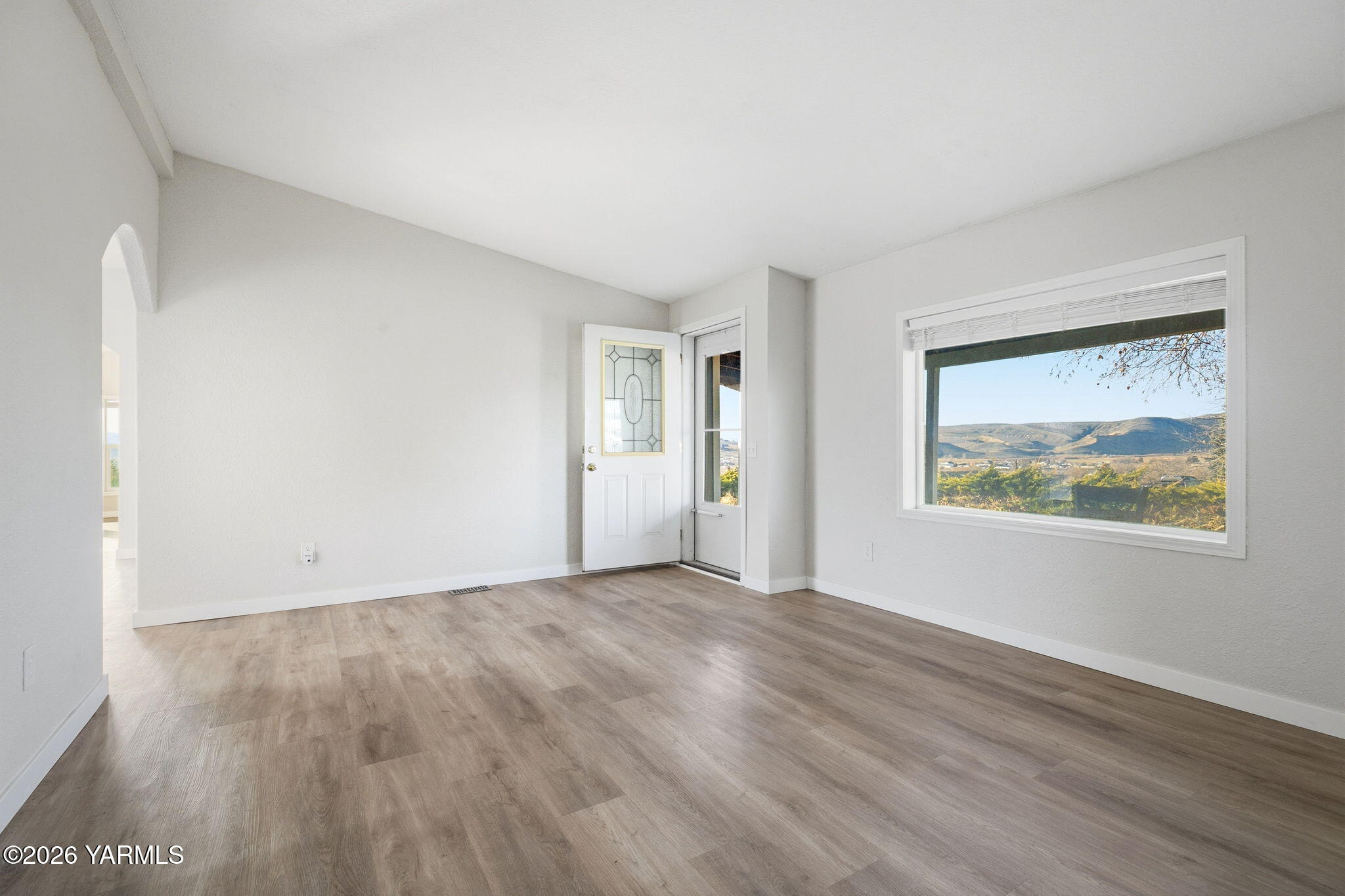 401 Clemans View Road Selah, WA 98942 - Photo 16 of 28 a view of an empty room with wooden floor and a window