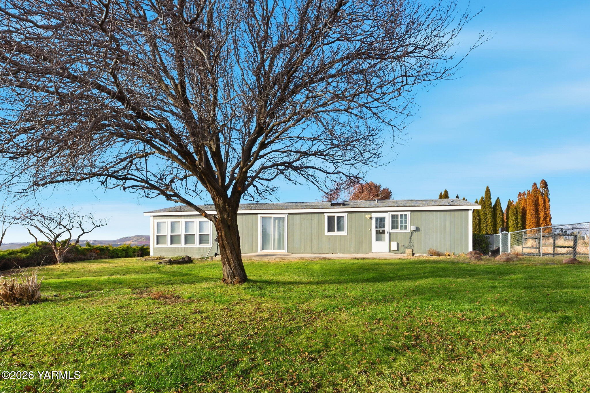401 Clemans View Road Selah, WA 98942 - Photo 7 of 28 a view of a house with a big yard and large trees