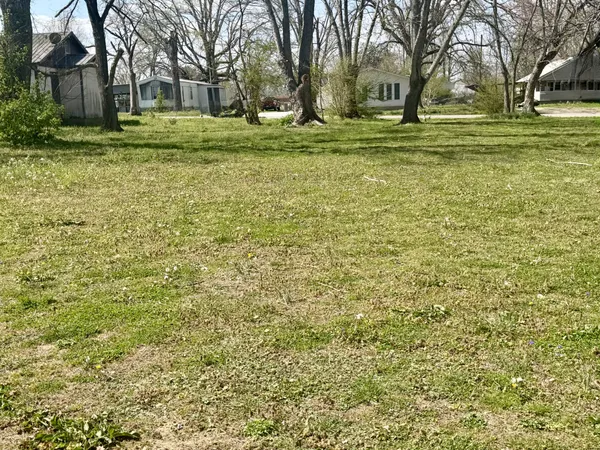 a backyard of apartments with large trees