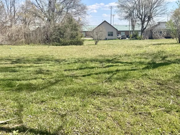 a view of open space with wooden fence