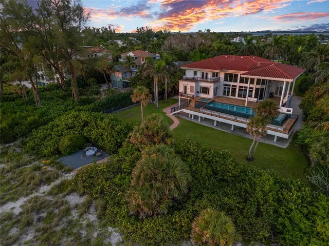 a living room with furniture fireplace and a large window