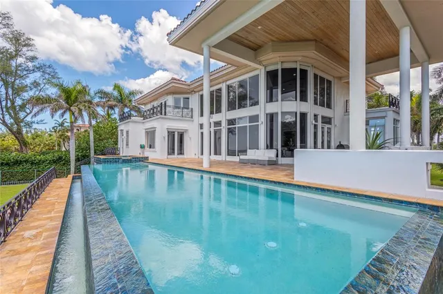 a view of a swimming pool with an outdoor space and seating area