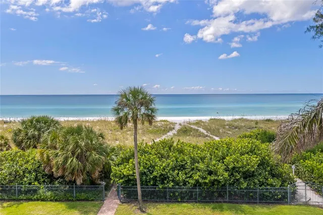 a view of a house with a yard table and chairs
