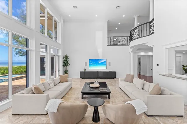 a living room with furniture and large windows