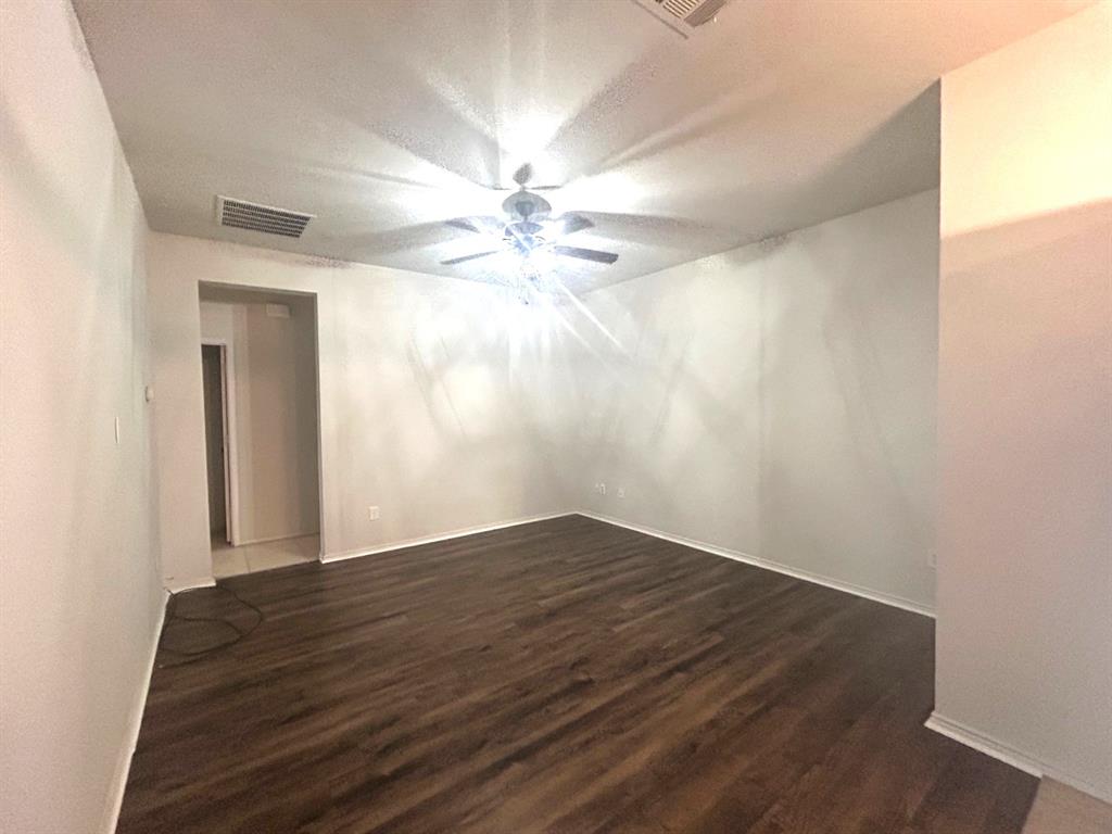6904 Cotton Seed Drive McKinney, TX 75070 - Photo 4 of 10 a view of an empty room with wooden floor