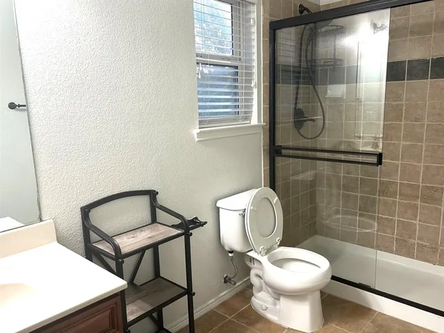 a white toilet sitting next to a bathroom sink