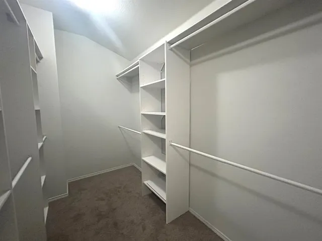 a view of an empty walk in closet