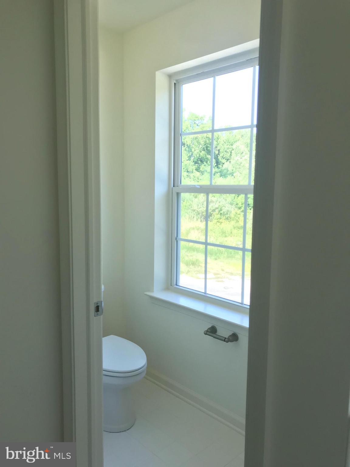 116 Grissom Drive Bear, DE 19701 - Photo 19 of 25 a bathroom with a toilet a sink and a window