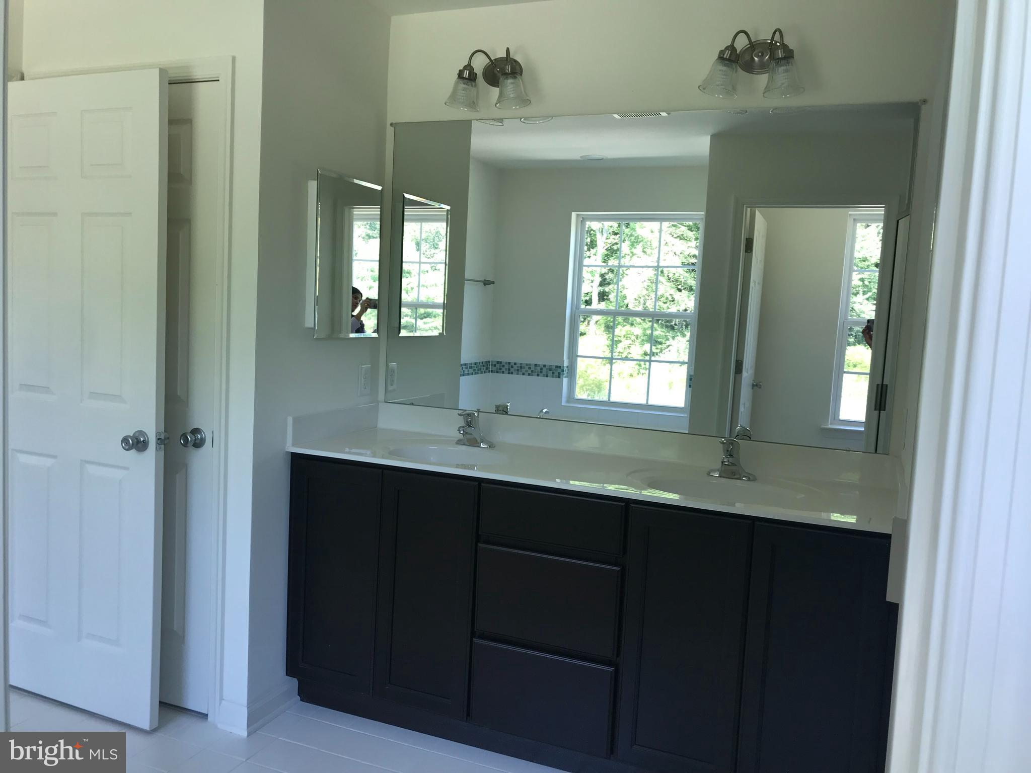 116 Grissom Drive Bear, DE 19701 - Photo 20 of 25 a bathroom with a double vanity sink and a mirror