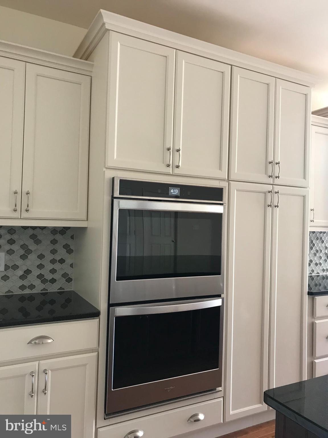 116 Grissom Drive Bear, DE 19701 - Photo 21 of 25 a kitchen with white cabinets and stainless steel appliances