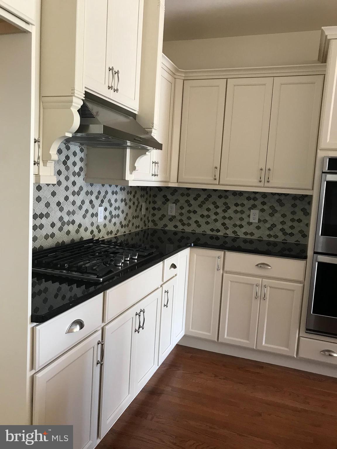 116 Grissom Drive Bear, DE 19701 - Photo 22 of 25 a kitchen with granite countertop white cabinets and white appliances
