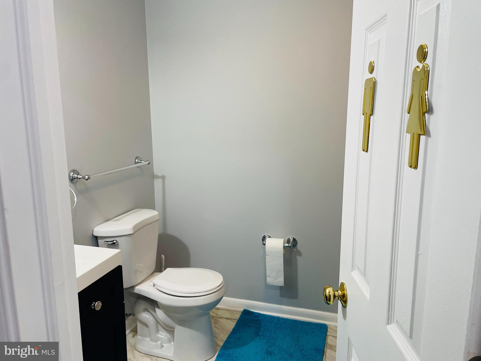 116 Grissom Drive Bear, DE 19701 - Photo 4 of 25 a white toilet sitting next to a bathroom sink