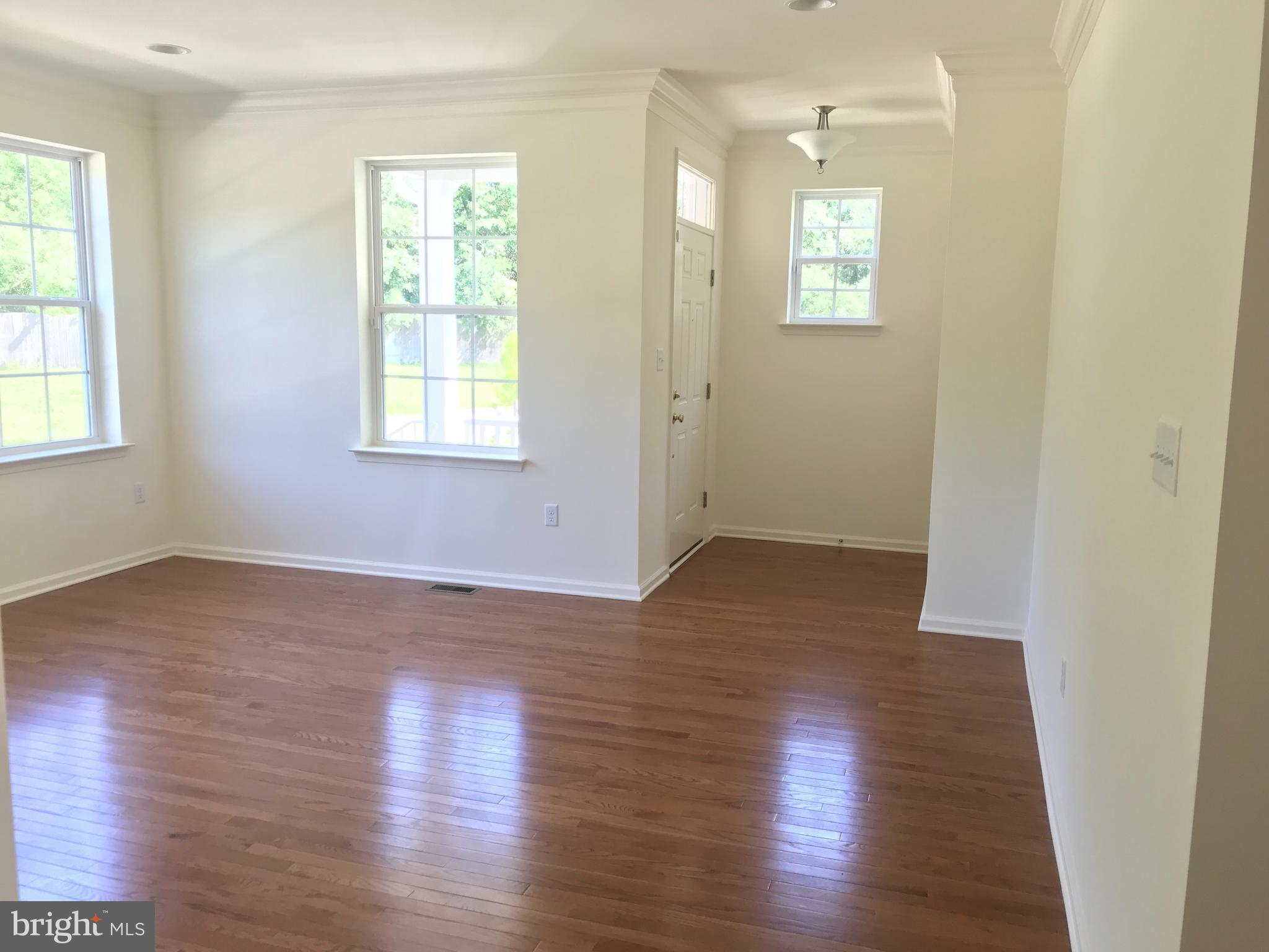116 Grissom Drive Bear, DE 19701 - Photo 6 of 25 an empty room with wooden floor and windows