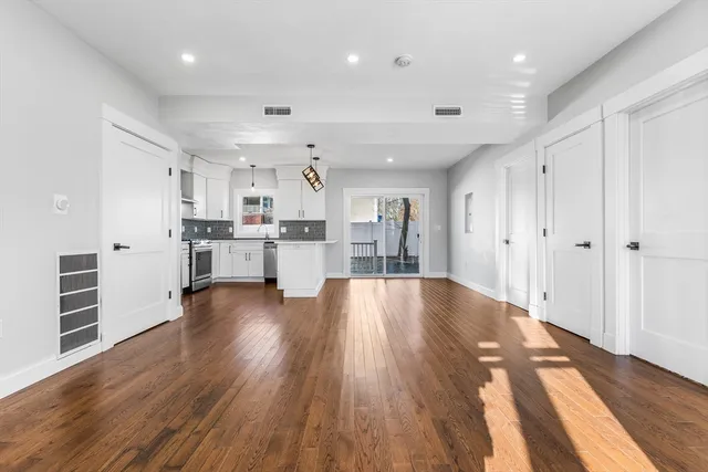 a view of kitchen with wooden floor and electronic appliances