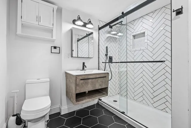 a bathroom with a sink toilet and shower