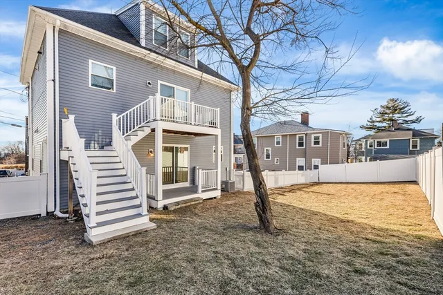 a view of a house with wooden fence