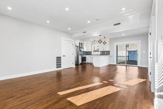 a view of a kitchen with a sink and wooden floor