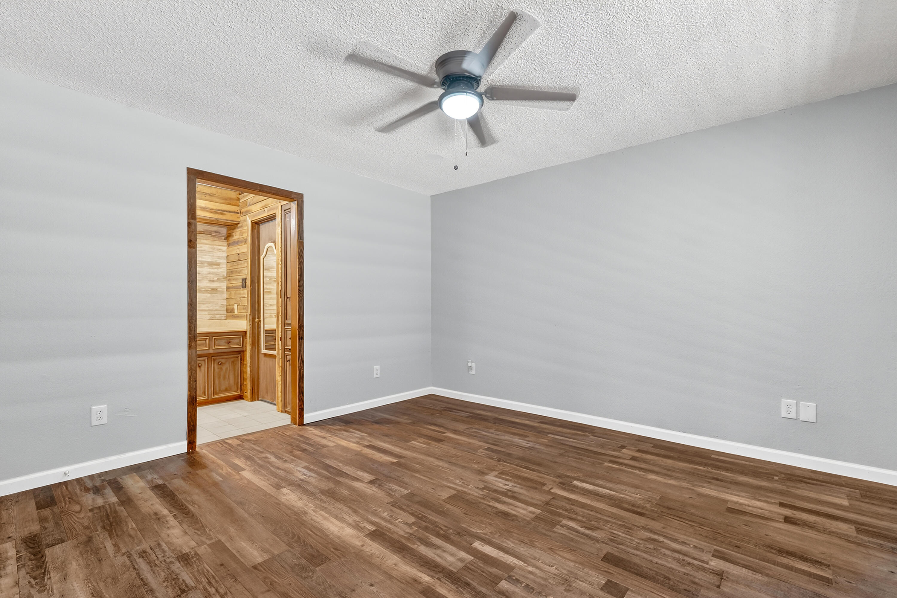 5236 91st Street Lubbock, TX 79424 - Photo 11 of 23 wooden floor in an empty room with a window
