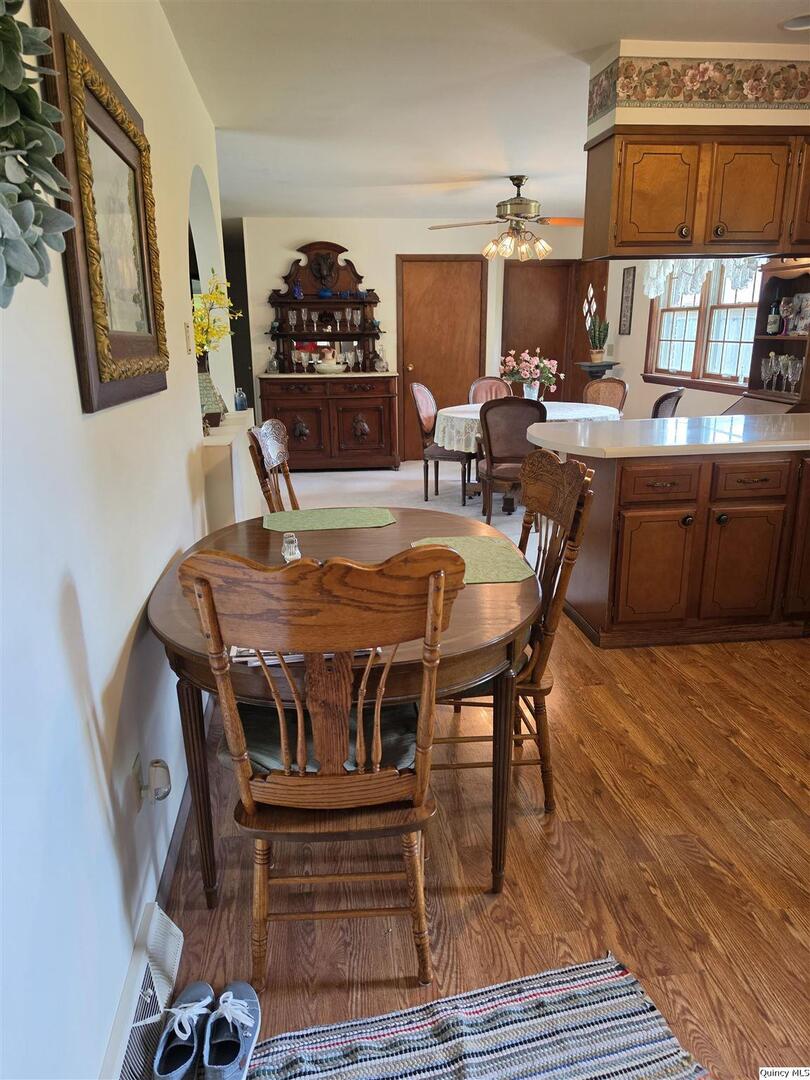103 East Spring Street Camp Point, IL 62320 - Photo 3 of 8 a view of a dining room with furniture and wooden floor