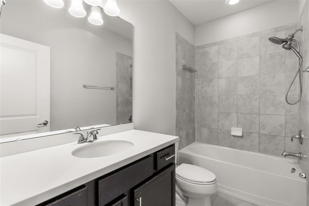 588 Piazza Point Oviedo, FL 32765 - Photo 45 of 66 a bathroom with a sink a toilet and a mirror