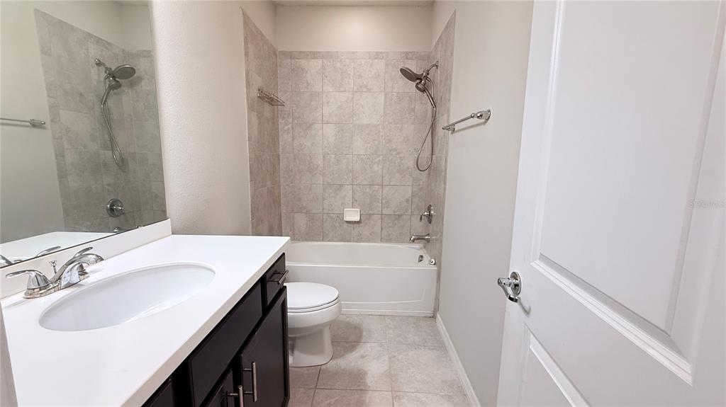 588 Piazza Point Oviedo, FL 32765 - Photo 53 of 66 a bathroom with a sink toilet vanity and shower