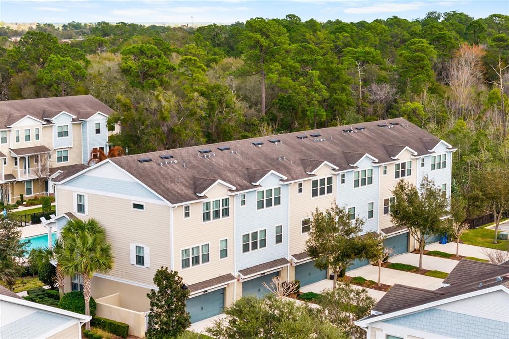 588 Piazza Point Oviedo, FL 32765 - Photo 65 of 66 a view of a white house with a big yard plants and large trees