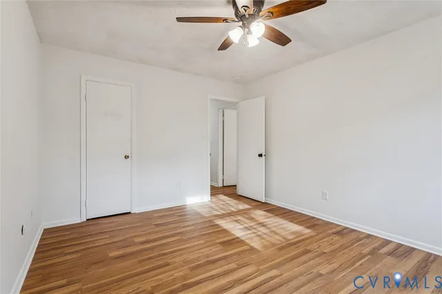 a view of a room with wooden floor