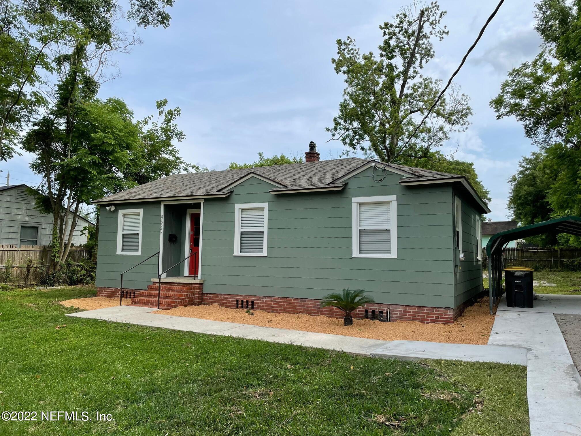 4520 Sunderland Road Jacksonville, FL 32210 - Photo 3 of 17 a backyard of a house with table and chairs