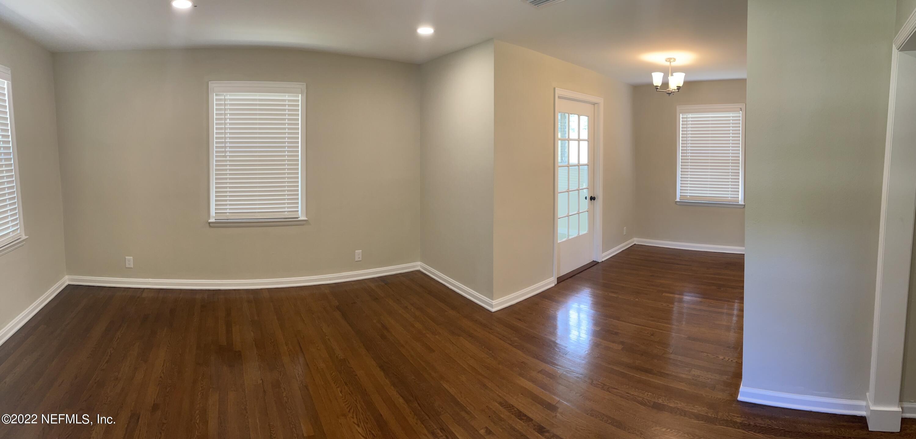 4520 Sunderland Road Jacksonville, FL 32210 - Photo 5 of 17 an empty room with wooden floor and windows