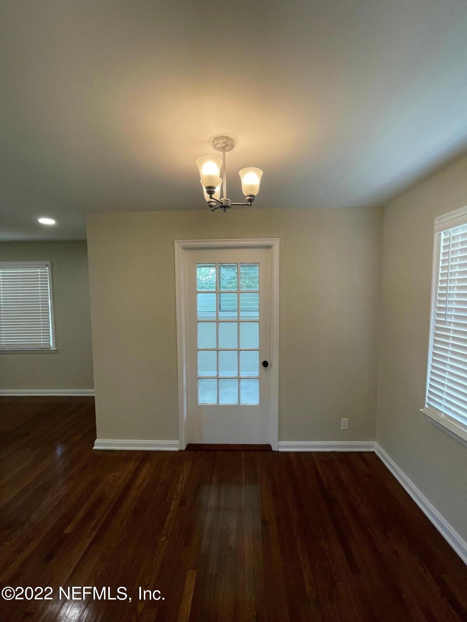 4520 Sunderland Road Jacksonville, FL 32210 - Photo 7 of 17 wooden floor in an empty room with a window