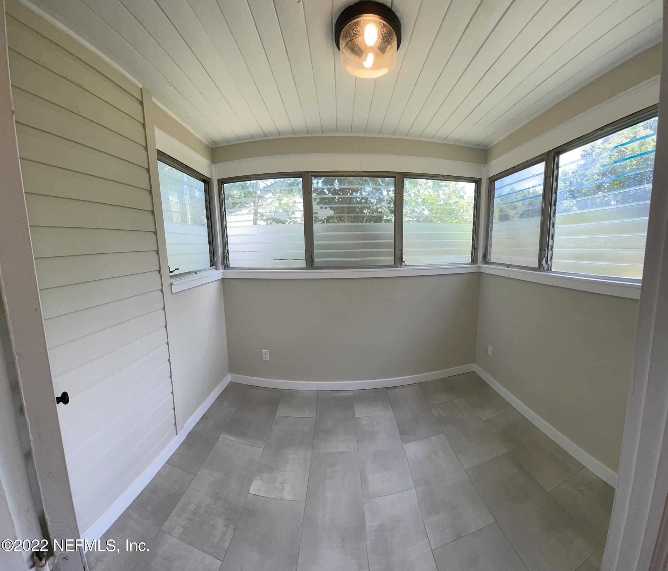 4520 Sunderland Road Jacksonville, FL 32210 - Photo 8 of 17 an empty room with windows