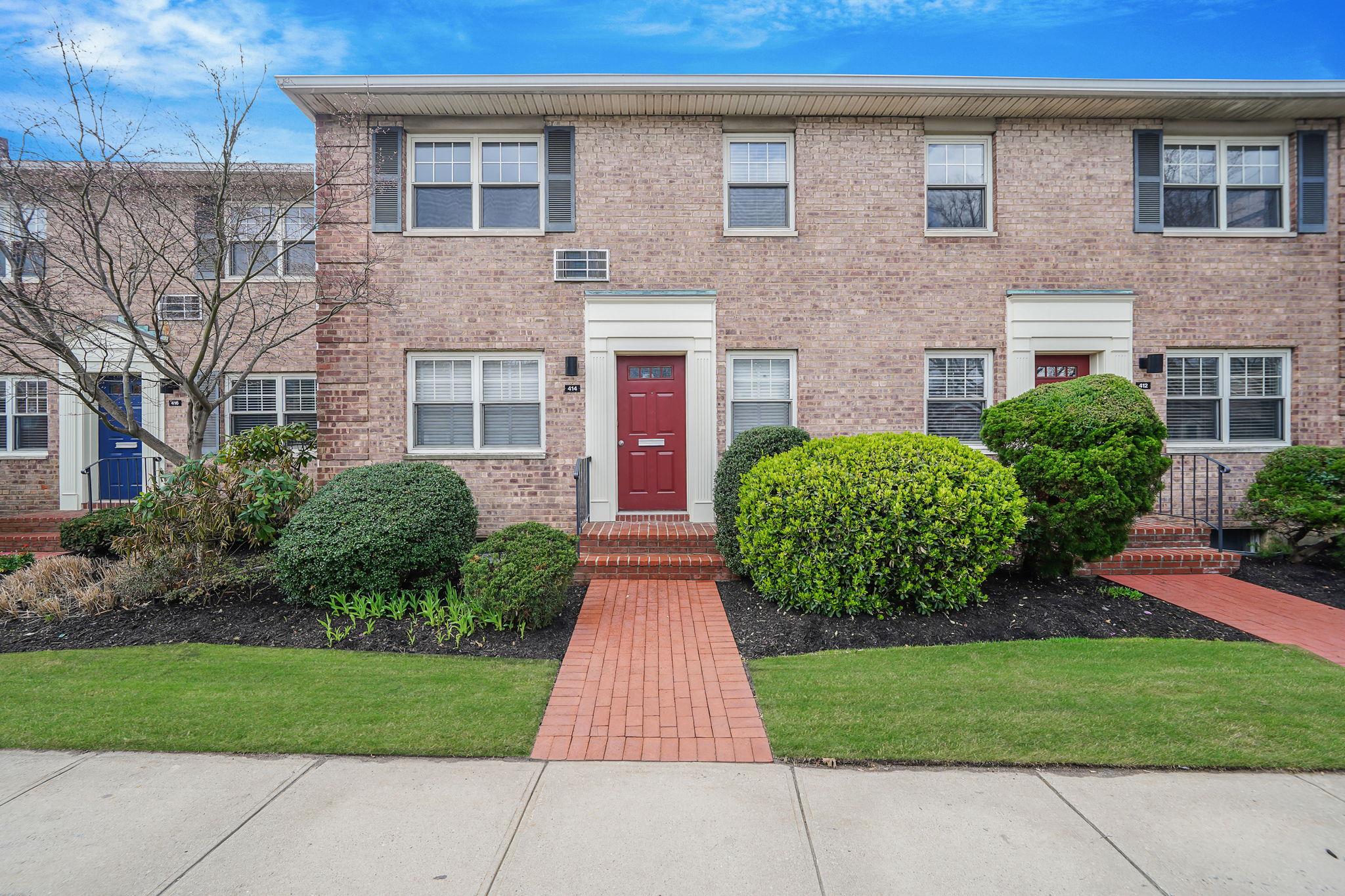 Multi unit property with brick siding and a front lawn