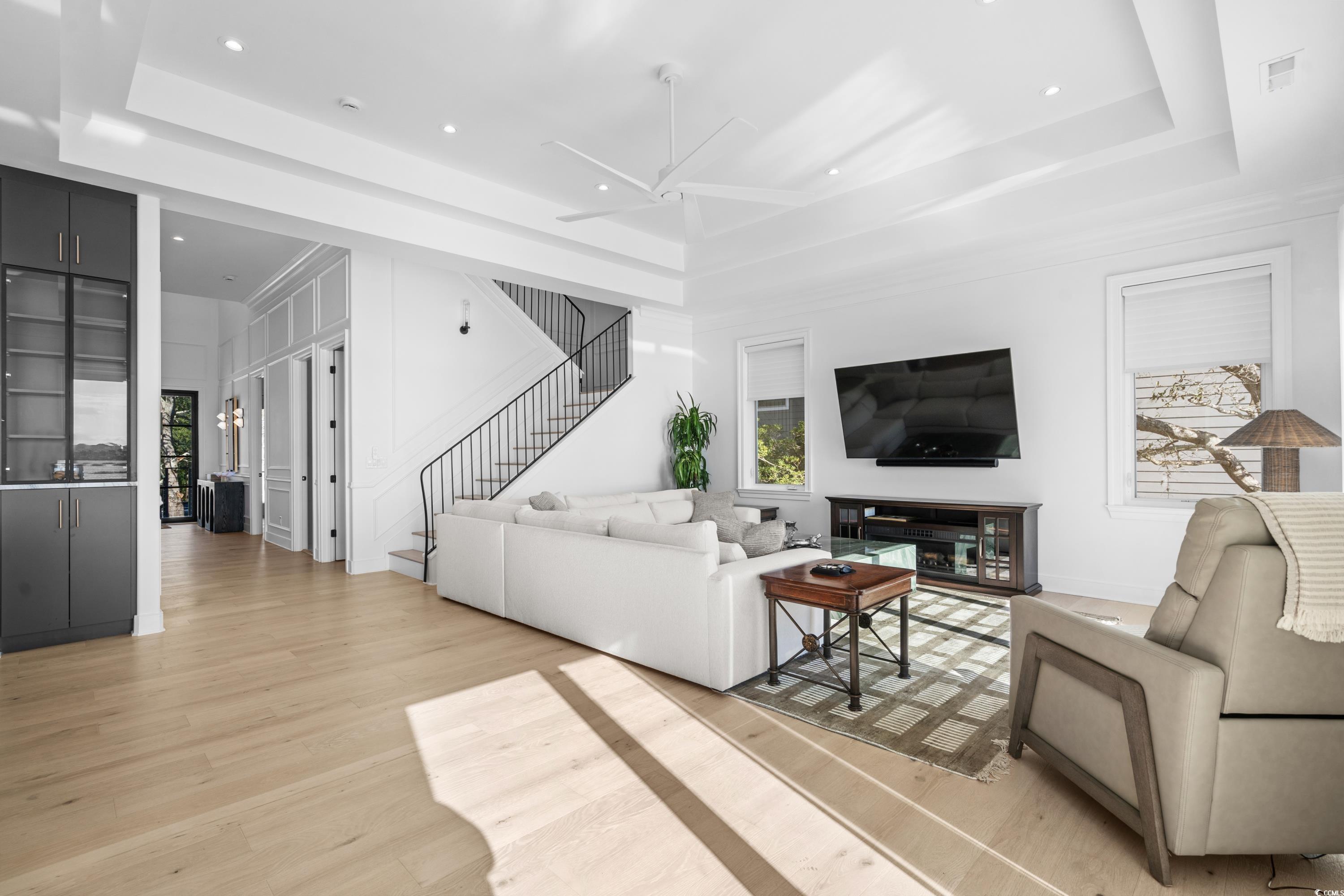 3109 State Rd S-26-816 Murrells Inlet, SC 29576 - Photo 16 of 40 Living room with ceiling fan, light wood-type flooring, and a tray ceiling