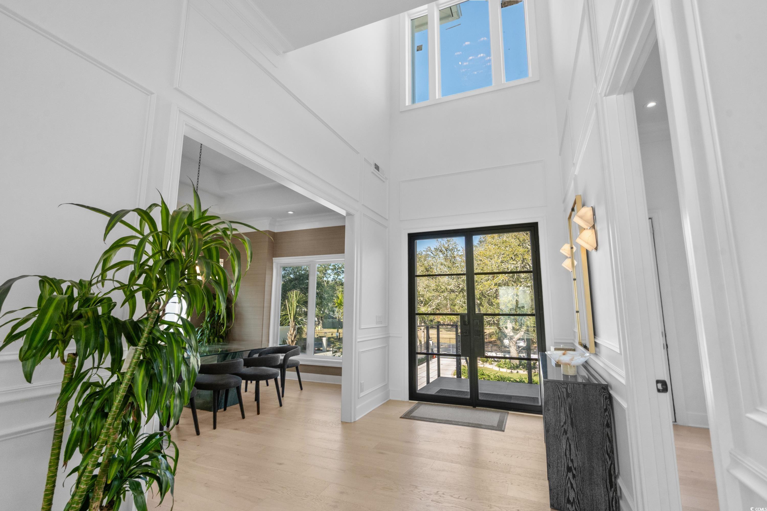 3109 State Rd S-26-816 Murrells Inlet, SC 29576 - Photo 8 of 40 Entryway with light wood-type flooring, a towering ceiling, and french doors