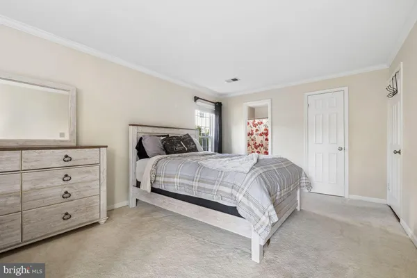 a bedroom with a bed and a night stand