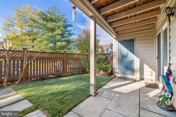 a view of a backyard with table and chairs and wooden fence