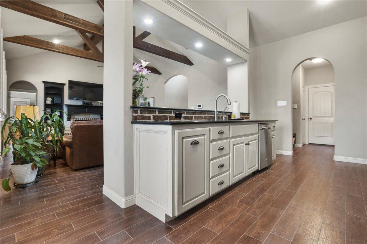 1125 17th Street Shallowater, TX 79363 - Photo 12 of 32 a kitchen with stainless steel appliances granite countertop a stove a sink and a refrigerator