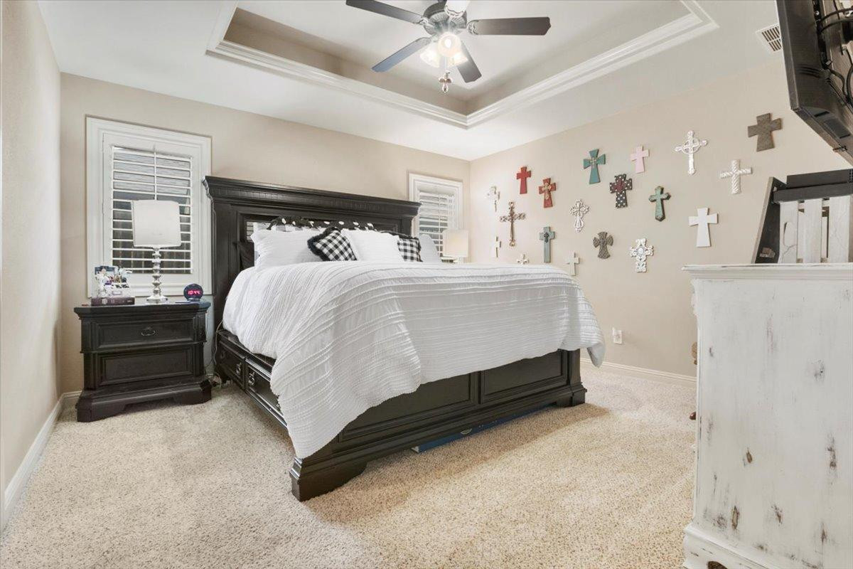 1125 17th Street Shallowater, TX 79363 - Photo 14 of 32 a bedroom with a bed and a chandelier