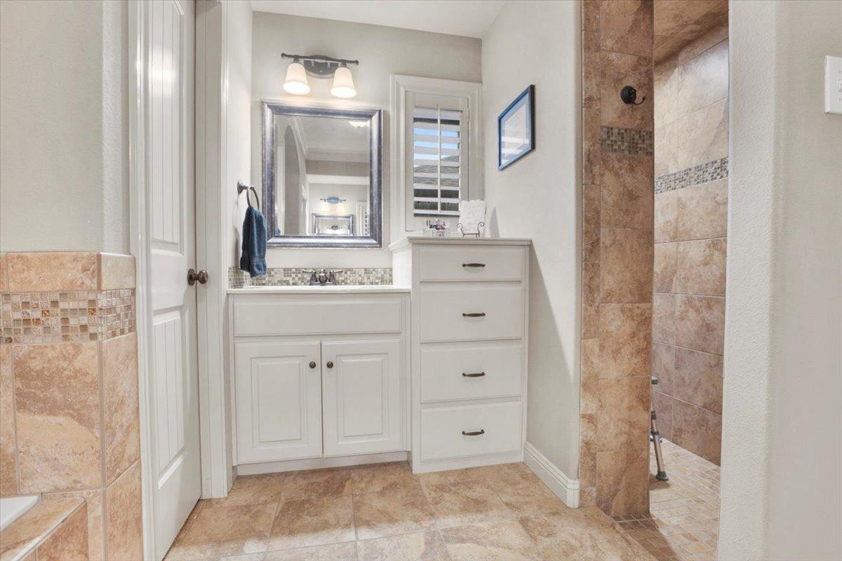 1125 17th Street Shallowater, TX 79363 - Photo 16 of 32 a bathroom with a sink and a mirror