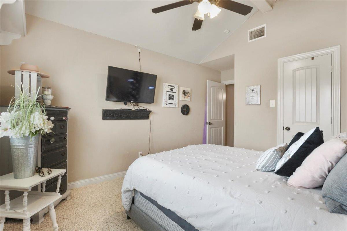 1125 17th Street Shallowater, TX 79363 - Photo 21 of 32 a bedroom with a bed and a flat screen tv