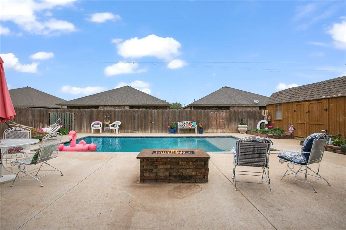1125 17th Street Shallowater, TX 79363 - Photo 28 of 32 a backyard of a house with fire pit and outdoor seating
