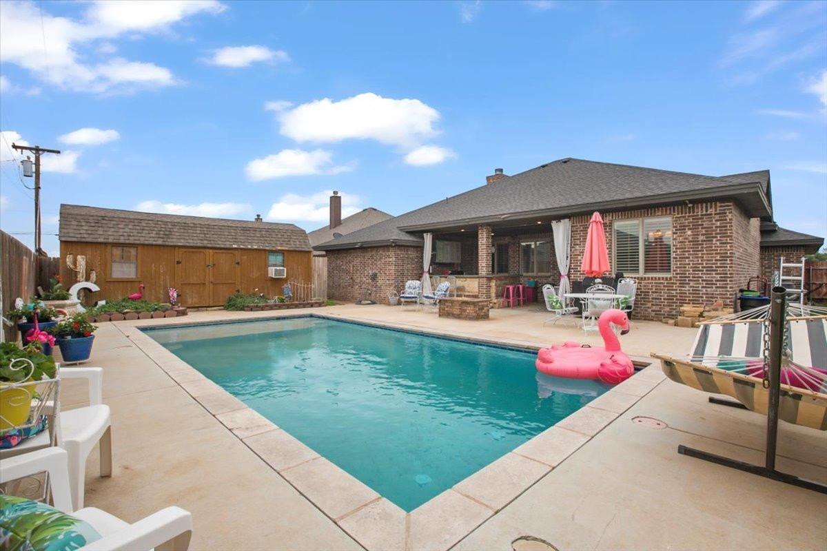 1125 17th Street Shallowater, TX 79363 - Photo 30 of 32 a view of a patio with swimming pool table and chairs