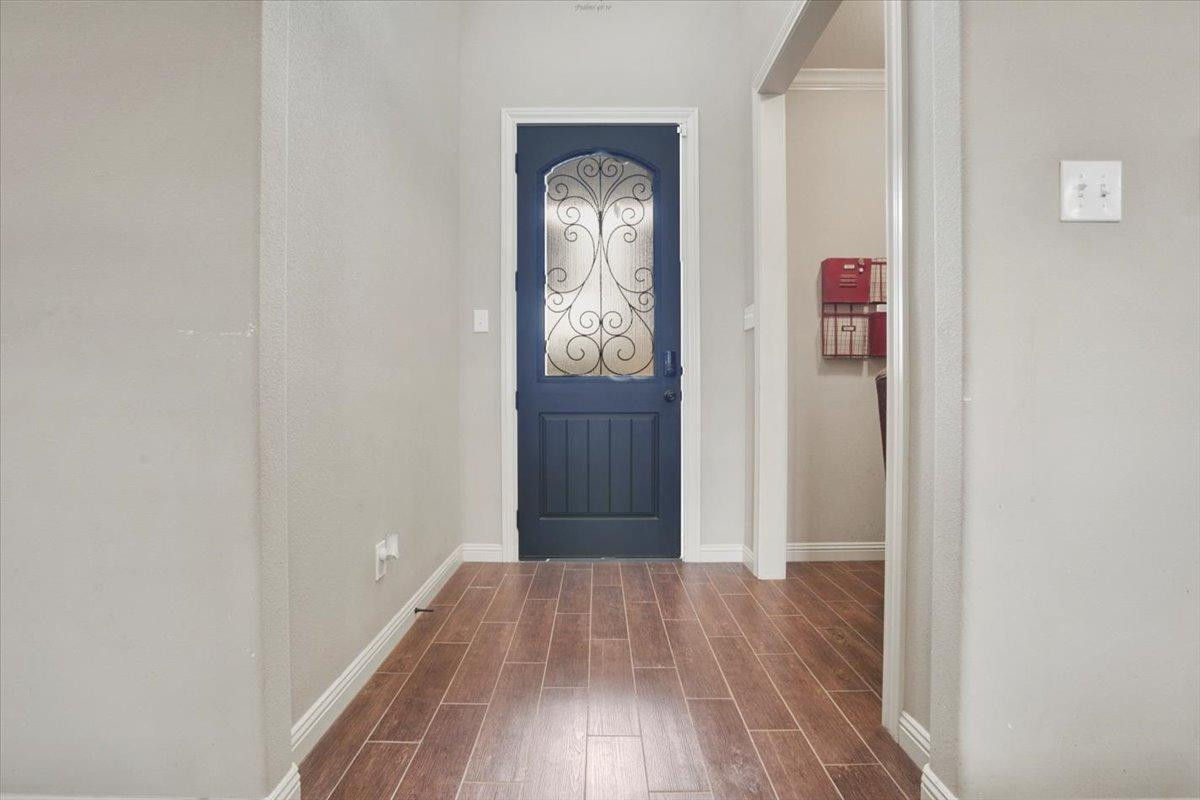 1125 17th Street Shallowater, TX 79363 - Photo 4 of 32 a view of a hallway with wooden floor