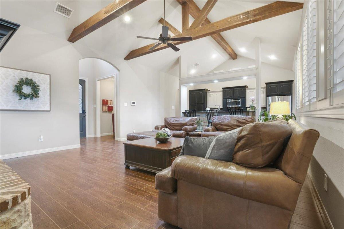 1125 17th Street Shallowater, TX 79363 - Photo 7 of 32 a living room with furniture kitchen view and a wooden floor