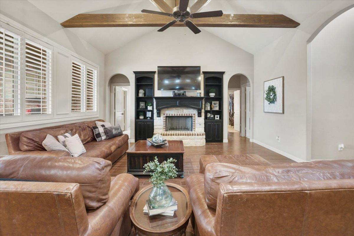 1125 17th Street Shallowater, TX 79363 - Photo 8 of 32 a living room with furniture and a fireplace