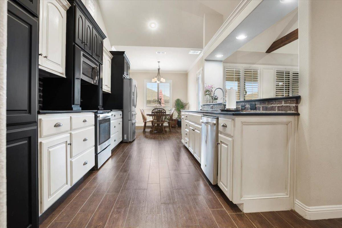 1125 17th Street Shallowater, TX 79363 - Photo 10 of 32 a kitchen with stainless steel appliances granite countertop a stove and a sink
