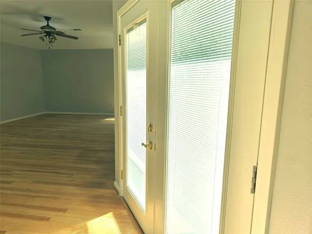 a view of water heater room with wooden floor