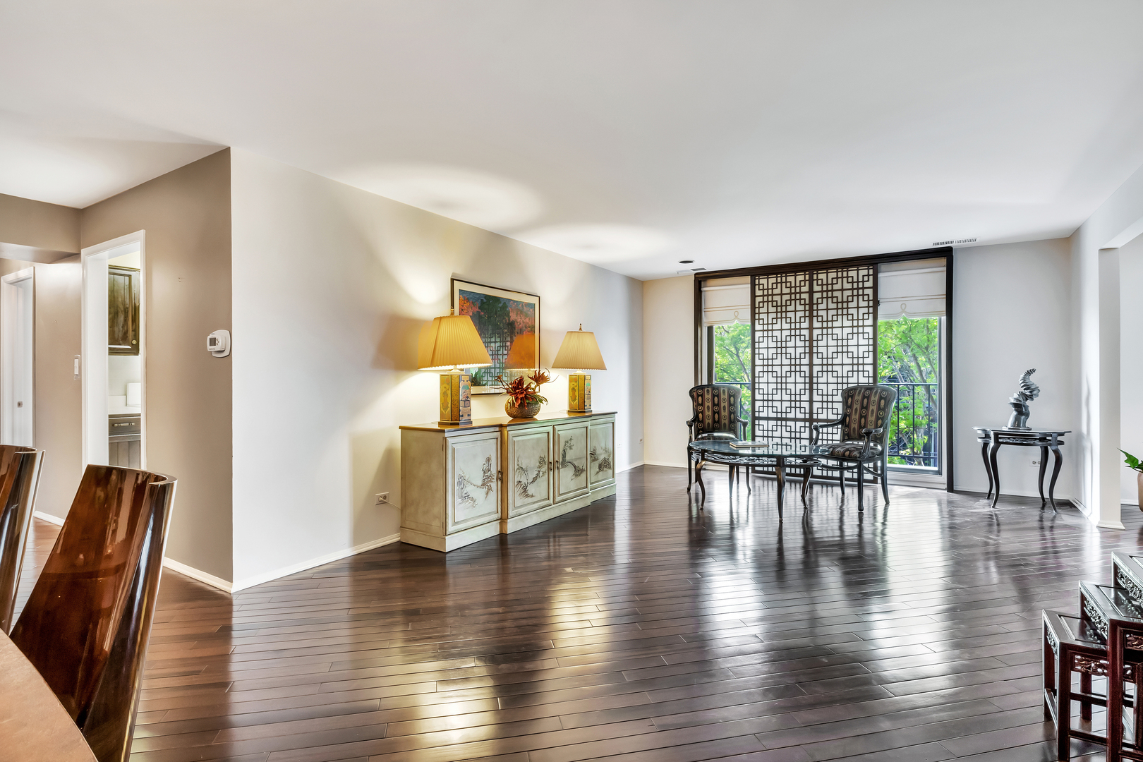9560 Gross Point Road, Unit 509B Skokie, IL 60076 - Photo 11 of 41 a living room with furniture and wooden floor next to a large window