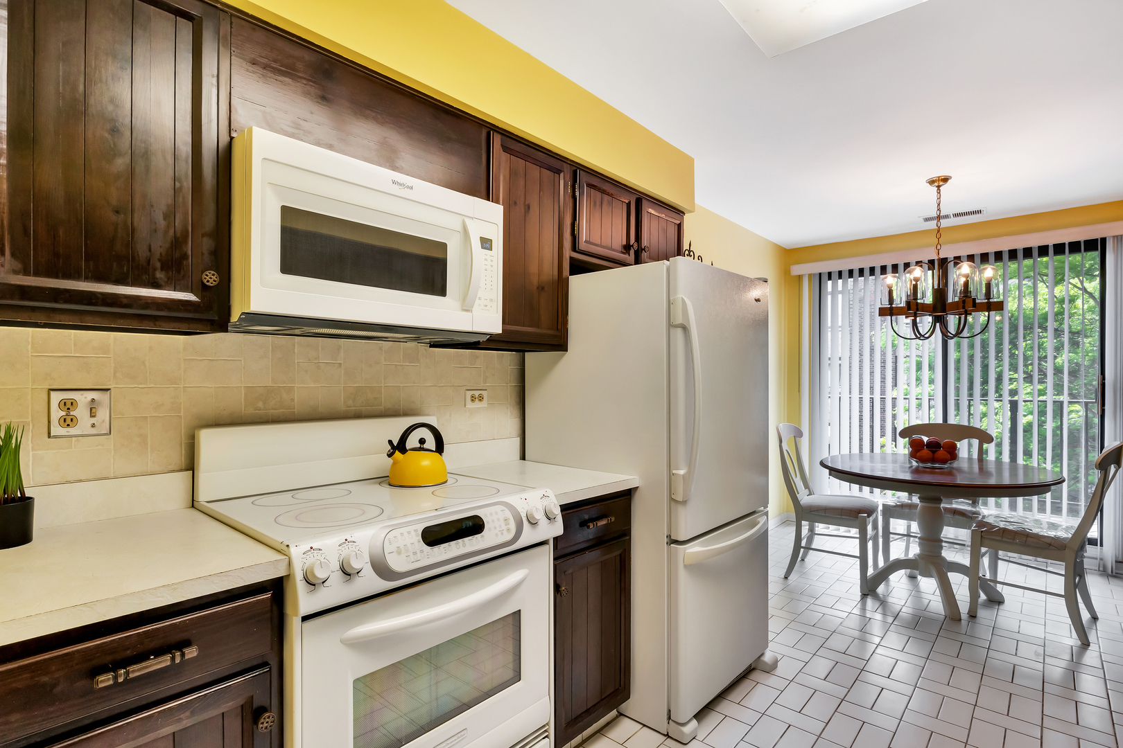 9560 Gross Point Road, Unit 509B Skokie, IL 60076 - Photo 15 of 41 a kitchen with a stove a sink and a refrigerator