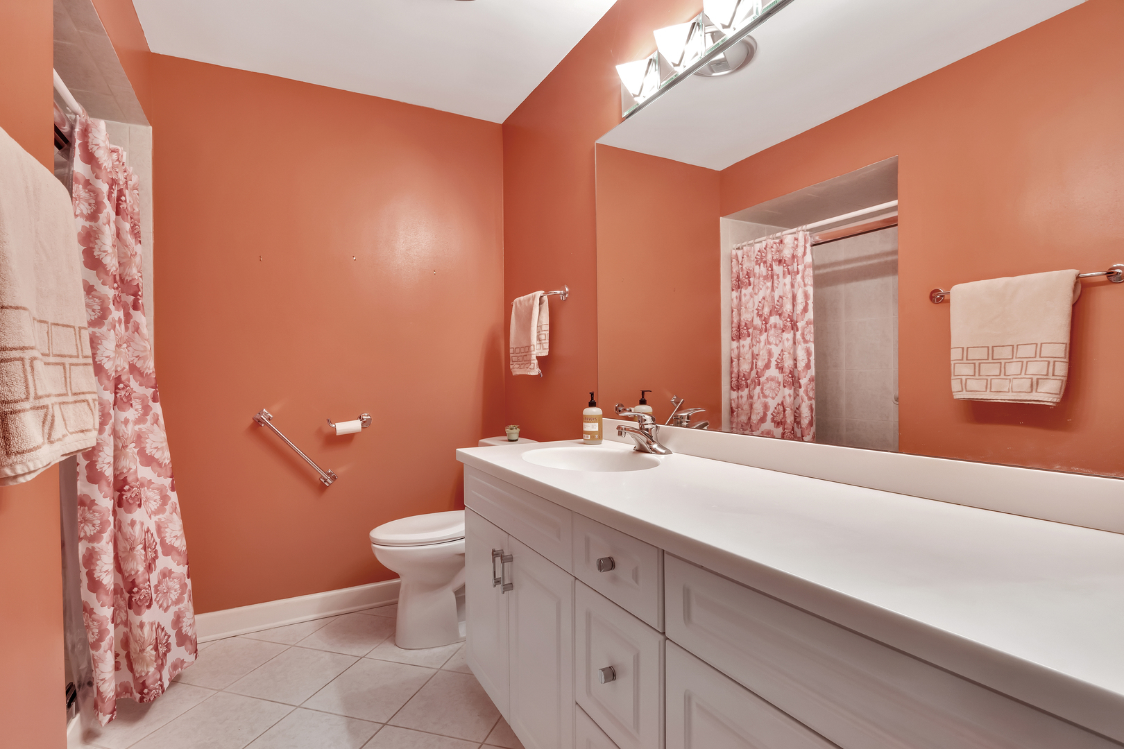 9560 Gross Point Road, Unit 509B Skokie, IL 60076 - Photo 26 of 41 a bathroom with a toilet sink and mirror